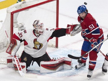 Ottawa Senators goalie Andrew Hammond deflects a shot past Montreal Canadiens' David Desharnais (51) during first period NHL hockey action.