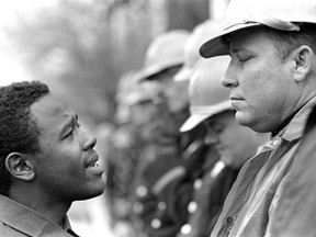 Willie Ricks, who would later join the Black Panthers and popularize the phrase "black power," faces a state trooper in Montgomery, Alabama in 1965.