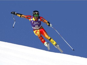 Dustin Cook, of Canada, the winner, speeds down the course during the alpine ski, men's World Cup super-G race, at the World Cup finals in Meribel, France, Thursday, March 19, 2015.