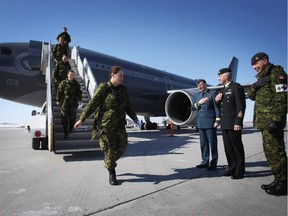 Soldiers disembark their aircraft at the Ottawa International Airport on Friday, March 6, 2015, as they return home from deployment in West Africa in support of global efforts to help prevent the spread of the Ebola virus.