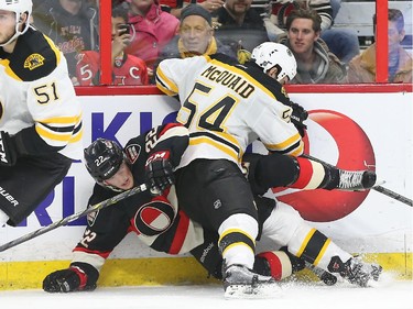 Erik Condra of the Ottawa Senators is hit by Adam McQuaid of the Boston Bruins during first period NHL action.