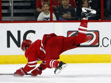Carolina Hurricanes' Chris Terry (25) is upended by Ottawa Senators' Erik Karlsson (65) during the first period.
