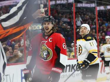 Erik Karlsson, left, of the Ottawa Senators and Gregory Campbell of the Boston Bruins both receive penalties during second period NHL action.