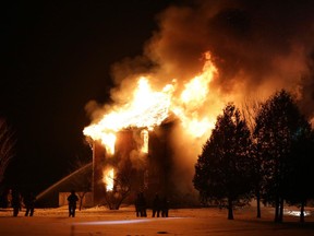 Firefighters battle a blaze on Limebank Road near Manotick early on Sunday, March 7, 2015.