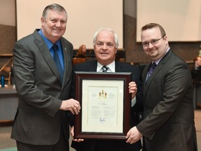 Jean Séguin receives the Mayor's City Builder Award from Deputy Mayor Bob Monette, left, and Coun. Stephen Blais.
