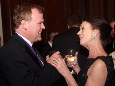 Former senior Conservative cabinet minister John Baird is greeted by Elly Meister at the Politics and the Pen dinner for the Writers' Trust of Canada, held at the Fairmont Chateau Laurier on Wednesday, March 11, 2015.
