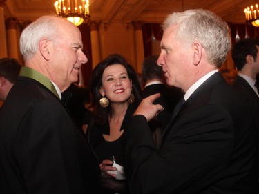 From left, author and CBC news anchor Peter Mansbridge in conversation with Vicki Heyman, wife of the U.S. Ambassador, and Bruce Anderson at the Politics and the Pen gala dinner for the Writers' Trust, held Wednesday, March 11, 2015, at the Fairmont Chateau Laurier.