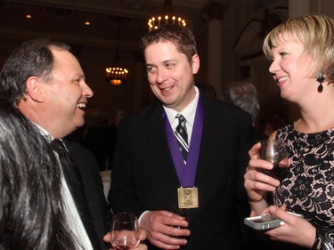 From left, Don Martin, host of CTV's Power Play, with Speaker of the House of Commons Andrew Scheer and his wife, Jill Scheer, co-chair of the Politics and the Pen dinner held at the Fairmont Chateau Laurier on Wednesday, March 11, 2015.