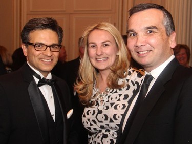 From left, Hill + Knowlton Strategies president and CEO Goldy Hyder with Heather Cudmore and Lou Riccoboni from CH2M HILL at the Politics and the Pen dinner held at the Fairmont Chateau Laurier on Wednesday, March 11, 2015.