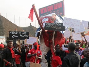 Supporters of Ghana's main opposition New Patriotic Party (NPP) hold placards during a demonstration in Accra against the worsening power crisis and economic challenges on February 18, 2015. Ghana is facing economic challenges amid the worst blackouts in a decade with the country's largest power producer lacking natural gas to fuel its plants and the water level at the largest hydropower facility near the minimum necessary to function.