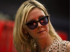 Glass maker Melody Jewitt keeps an eye on the red-hot glass as it spins inside a 2000 degree kiln.