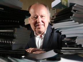 Glenn Stannard, outgoing Chairman of the Military Police Complaints Commission, sits amidst a fraction of the pages from the Fyne's Report, which covers testimony from 90 witnesses over 62 days last year.  (Julie Oliver / Ottawa Citizen)