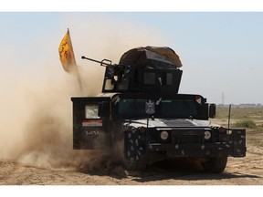 Iraqi government forces take part in a military operation to retake control of Tikrit, 160 kms north of Baghdad, from jihadists from the Islamic state (IS) group, on March 11 2015. Iraqi forces entered a northern neighbourhood of Tikrit, marking a new stage in the operation launched 10 days ago to wrest the city back from jihadists, army officers said.