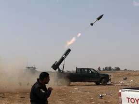 Iraqi security forces launch a rocket against Islamic State extremist positions during clashes in Tikrit, 130 kilometers (80 miles) north of Baghdad, Iraq, Monday, March 30, 2015.