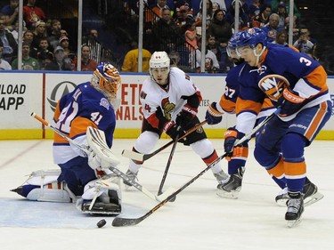 New York Islanders goalie Jaroslav Halak (41), defenseman Travis Hamonic (3) and defenseman Brian Strait (37) defend against Ottawa Senators center Jean-Gabriel Pageau (44) in the first period.