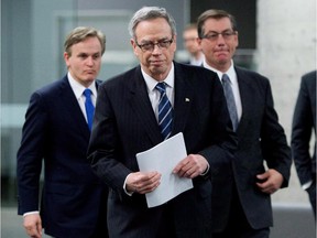 Finance Minister Joe Oliver, middle, makes his way to the podium with Minister of State (Finance) Kevin Sorenson, right, and Parliamentary Secretary to the Finance Minister, Andrew Saxton prior to the finance ministers meeting in Ottawa on Dec. 15, 2014.
