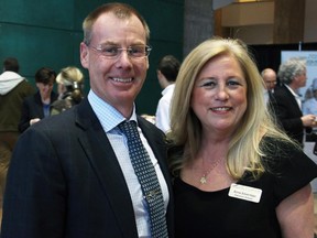 John Lindsay, vice president and senior investment counsellor with BMO Wealth Management, and Shepherds of Good Hope Foundation executive  director Anna Silverman at A Taste for Hope culinary beneift for Ottawa's poor and homeless held at City Hall on Wednesay, March 25, 2015.