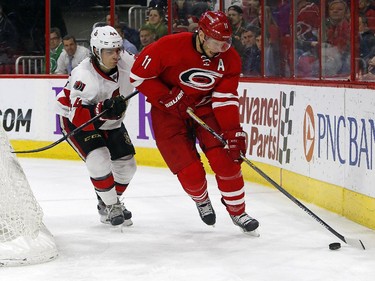 Carolina Hurricanes' Jordan Staal (11) battles Ottawa Senators' Jean-Gabriel Pageau (44) for the puck during the second period.