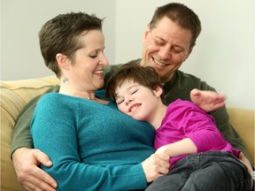 Julie Keon with husband Tim Graham and daughter Meredith Graham, 11, has written a book about caring for their daughter with cerebral palsy.