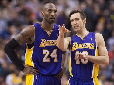 Los Angeles Lakers guards Kobe Bryant, right, and Steve Nash, right, talk during a time-out while playing against the Toronto Raptors during first half NBA basketball action in Toronto on Sunday, January 20, 2013.