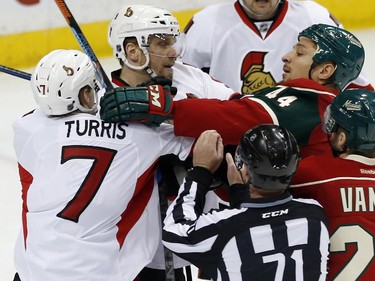 Ottawa Senators' Kyle Turris, left, and Minnesota Wild's Chris Stewart, right, mix it up briefly as Ottawa Senators' Milan Michalek, second from left, of Czech Republic, joins the fray in the first period.