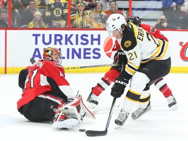 Loui Ericsson of the Boston Bruins scores on Craig Anderson and Cody Ceci of the Ottawa Senators during second period NHL action.