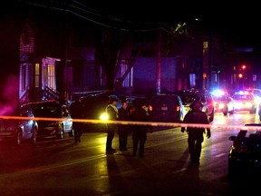 Madison Police investigate the scene of a shooting on Williamson Street, late Friday, March 6, 2015 in Madison, Wis.  A 19-year-old black man died Friday night after being shot by an officer in Madison, authorities said. The man was shot after an altercation with the officer and died at a hospital, Police Chief Mike Koval said. He did not know if the man was armed, but said the "initial findings at the scene did not reflect a gun or anything of that nature that would have been used by the subject.