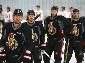 Men in black: Marc Methot, Erik Karlsson, Eric Gryba and Cody Ceci share a laugh during Monday morning practice at the Bell Sensplex.
