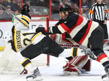 Marc Methot (R) of the Ottawa Senators pushes Loui Eriksson of the Boston Bruins during second period of NHL action at Canadian Tire Centre in Ottawa, March 19, 2015.   (Jean Levac/ Ottawa Citizen)