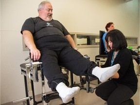 Marc Souliere gets some assistance from physiotherapist Cindy Appleby as he prepares to lift weights with his legs following recent knee surgery. The Total Joint Assessment Clinic program was developed by staff at Queensway-Carleton Hospital and recently was expanded to all hospitals doing joint surgery in the Champlain LHIN.