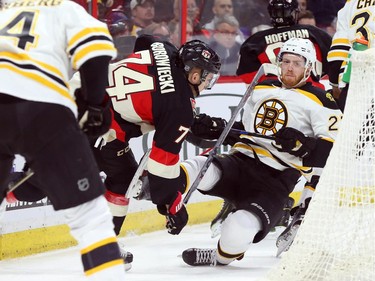 Mark Borowiecki of the Ottawa Senators hits Dougie Hamilton of the Boston Bruins during first period NHL action.