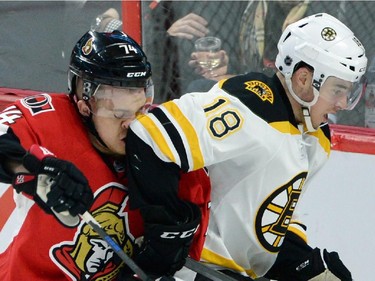 Ottawa Senators' Mark Borowiecki gets an elbow in the face from Boston Bruins' Reilly Smith during first period NHL action.