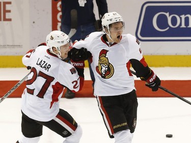 Ottawa Senators' Mark Stone, right, celebrates his shootout goal with Curtis Lazar (27) against the Detroit Red Wings during an NHL hockey game in Detroit Tuesday, March 31, 2015. Ottawa won 2-1 in a shootout.
