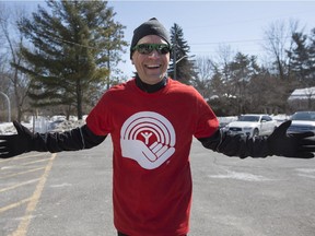 Mark Sutcliffe arrives midway through his 50 kilometer run at The Boys and Girls Club to recieve a ceremonial check on behalf of Surgenor Buick GMC on March 24. Sutcliffe, United Way campaign co-chair, is running across Ottawa to raise funds for United Way's Community Campaign. (Graeme Murphy / Ottawa Citizen)