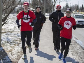 Mark Sutcliffe, right, is joined by Paul Steeves, left, of United Way, Stéphane Giguere, left read, CEO of Ottawa Community Housing, and Ottawa police Chief Charles Bordeleau, back right, on his run across Ottawa Tuesday.