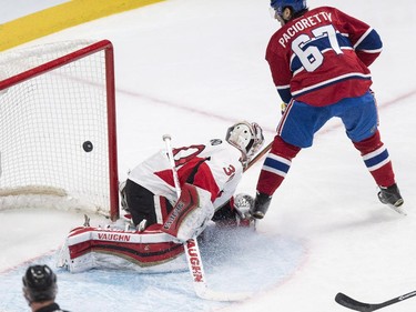 Montreal Canadiens' Max Pacioretty scores a short-handed goal past Ottawa Senators goalie Andrew Hammond during first period NHL hockey action.