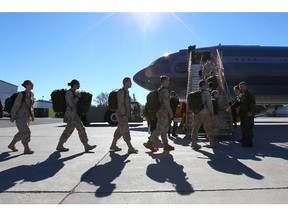 Members of the Canadian Forces board an Airbus CC-150 Polaris at CFB Trenton in Trenton, Ont., on Thursday, Oct. 23, 2014. The Canadian forces will help fight the ISIL and be based out of Kuwait City, Kuwait.