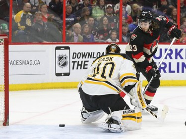 Mika Zibanejad, right, of the Ottawa Senators gets out of the way of the puck that beat Tuukka Rask of the Boston Bruins but did not end up in the net on the play during first period NHL action.