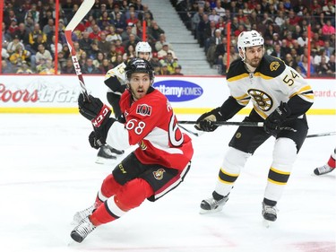 Mike Hoffman of the Ottawa Senators in action against Adam McQuaid of the Boston Bruins during first period NHL action.