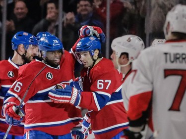 Montreal Canadiens defenseman P.K. Subban, left, congratulates teammate Montreal Canadiens left wing Max Pacioretty, right, after he scored the Canadiens second goal against the Ottawa Senators during the first period.