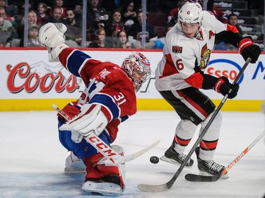 Montreal Canadiens goalie Carey Price, left, makes a save against Ottawa Senators right wing Bobby Ryan, right, during the first period.