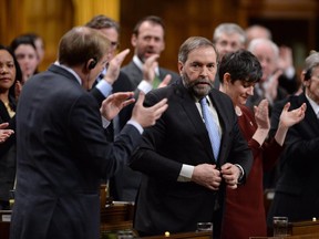 NDP Leader Tom Mulcair receives applause after asking a question during Question Period in the House of Commons in Ottawa on Wednesday, March 25, 2015.