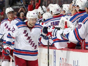 Dan Boyle #22 of the New York Rangers celebrates his first period goal against the Ottawa Senators with team mates on the bench.