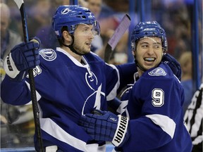 Tampa Bay Lightning right wing Nikita Kucherov, left, of Russia, celebrates with teammate center Tyler Johnson after scoring a goal against the Arizona Coyotes during the second period of an NHL hockey game Tuesday, Oct. 28, 2014, in Tampa, Fla.