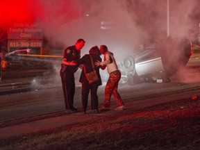 At 9:30pm a single vehicle driving East on Hazeldean Rd in Kanata hit the median and light post causing the vehicle to flip over. The driver, an 18year old male escaped without serious injuries. The police and emergency crews were quick to respond. My wife and I heard the crash while in our house and quickly ran to help. After emergency crews arrives and I knew no one else was hurt, I went and grabbed my camera. My wife waited for the driver's parents to come onto the scene and help console his mother as she passed the crash.