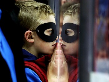 Noah Bradburn as the Hamburglar watches his team warm up before the game.