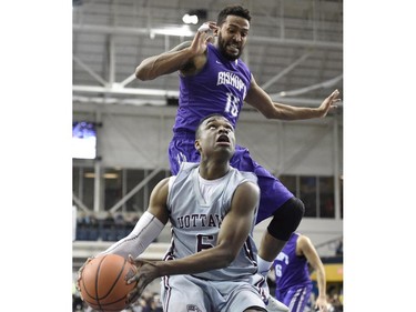 Ottawa Gee Gees' Caleb Agada (6) drives to the basket as Bishop's Gaiters' Karim Sy-Morissette (15) defends during first half CIS Final Eight basketball action in Toronto on Thursday, March 12, 2015.