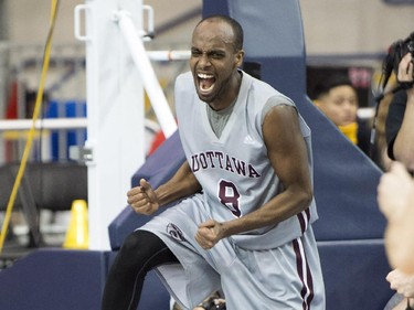 Ottawa Gee Gees' Johnny Berhanemeskel (8) celebrates a crucial basket in fourth quarter quarter final action against Bishops in CIS Final Eight basketball action in Toronto on Thursday, March 12, 2015.