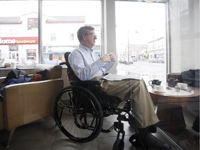 Ottawa Mayor Jim Watson, in wheelchair, at a Glebe coffee shop recently. He has been off after breaking his pelvis in a snowmobile accident and returns to work half-days next week.