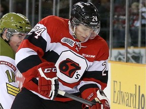 OTTAWA, ON: FEBRUARY 08, 2015 -- Nevin Guy #24 of the Ottawa 67's battles for the puck against Ray Huether #10 of the North Bay Battalion, during OHL action at TD Place, in Ottawa, ON, on February 08, 2015.  (For SPRT Section)